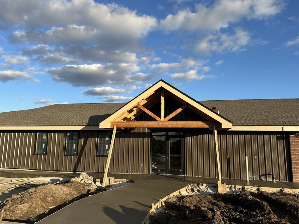 one story building under construction with wet pavement drying